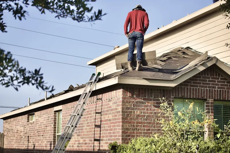 Professional roofer working on a residential roof in Ponders Corner